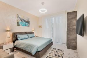 a bedroom with a bed and a television in it at luxury apartament in Viareggio