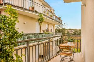 a balcony with two chairs and a table on it at luxury apartament in Viareggio