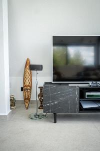 a living room with a flat screen tv on a entertainment center at Villa Gaia Novi Grad in Jablanica