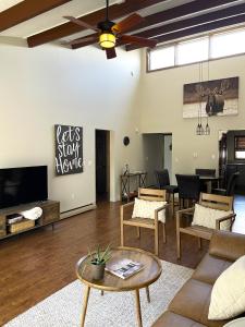 a living room with a couch and a tv at Fun on Moosehead Lake in Greenville Junction