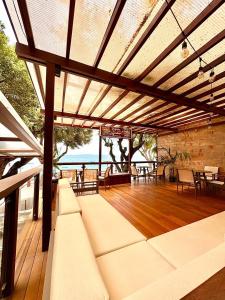 a patio with white couches on a wooden deck at Hit Hotel in Salvador