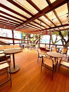 a restaurant with tables and chairs and a deck at Hit Hotel in Salvador