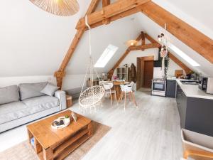 a living room with a couch and a table at Mackenheim - Parenthèse détente en Alsace - Terrasse & Parking in Mackenheim