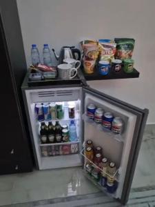 a small refrigerator filled with lots of drinks at Malaga palace in Soûr