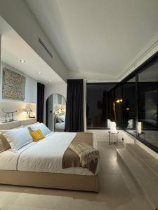 a bedroom with a large bed and a large window at Villa Luna maison d'architecte in Marseille