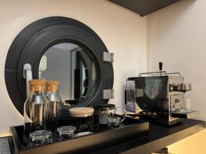 a counter with a mirror and a coffee maker and a microwave at Villa Luna maison d'architecte in Marseille