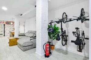 a living room with a fire hydrant and bikes on the wall at Alojamiento Simon 1 Murcia in Murcia