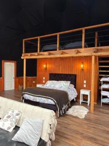 a bedroom with two beds and an upper bunk at Domo ancud glamping in Lechagua