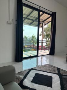 a living room with a view of a pool at Golden Beach Resort Koh Phangan in Ban Tai