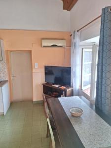 a living room with a table and a television at Apartman Boljević in Podgorica