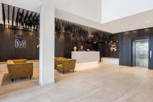 a lobby with chairs and a counter in a building at The Mayfair in Christchurch