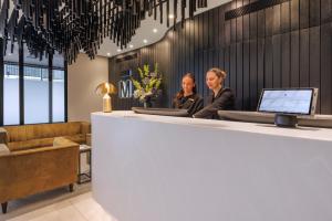 two women sitting at a counter in a lobby at The Mayfair in Christchurch +29 photos