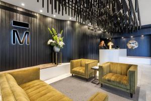 a lobby with two chairs and a waiting room at The Mayfair in Christchurch