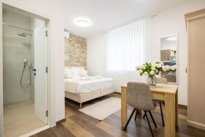 a bedroom with a bed and a table with a chair at Split Varos Inn in Split +67 photos