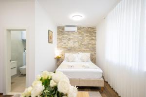 a bedroom with a bed and a brick wall at Split Varos Inn in Split
