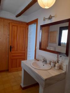 a bathroom with a sink and a mirror at Casa-Huerto La Juana in Trevélez +44 photos