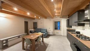 a kitchen and living room with a table and a counter at Forlì City Residence in Forlì