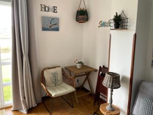 a living room with a chair and a table at Rincon en el Rio Sella in Ribadesella