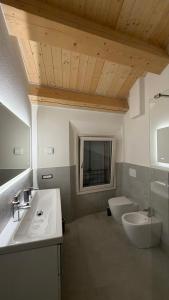 a bathroom with a sink and a toilet and a mirror at Forlì City Residence in Forlì +77 photos
