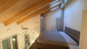 a small bedroom with a bed and a window at Forlì City Residence in Forlì