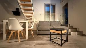 a living room with a couch and a table at Forlì City Residence in Forlì