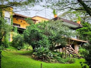 a yellow house with a staircase in front of it at Le Chemin Guesthouse - 6 sleeper in Kloof