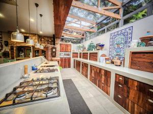 a large kitchen with a stove top oven in it at Le Chemin Guesthouse - 6 sleeper in Kloof