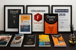 a table with a bunch of books and posters at Design Hotel & Restaurant Löwen in Ulm