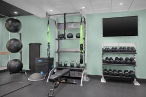 a room with a gym with weights and a flat screen tv at Tru By Hilton Stockbridge in Stockbridge
