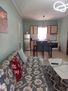 a living room with a couch and a kitchen at VATA apartaments in Thessaloniki +17 photos