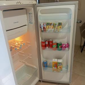 an open refrigerator with food and drinks in it at Microcasa na região do lago in Cascavel