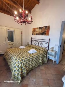 a bedroom with a bed and a chandelier at Le dimore del Mercante in Luco neʼ Marsi