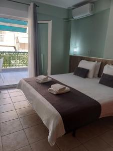 a bedroom with two beds with towels on them at VATA apartaments in Thessaloniki
