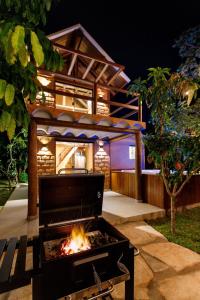 a fire pit in front of a house at night at Chalé com hidro em meio a natureza in Brasília