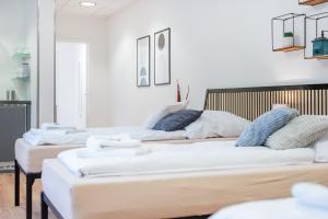 a group of three beds in a room at Orange Suite Schliengen 2 in Schliengen