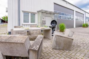 a patio with a table and benches in front of a building at Orange Suite Schliengen 2 in Schliengen