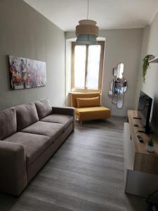 a living room with a couch and a chair at Casa di ringhiera 1 in Pinerolo