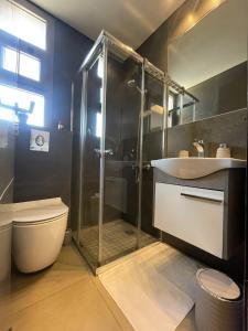a bathroom with a shower and a toilet and a sink at Mini 1BR Studio Central Broumana with Sea View in Broummana +18 photos
