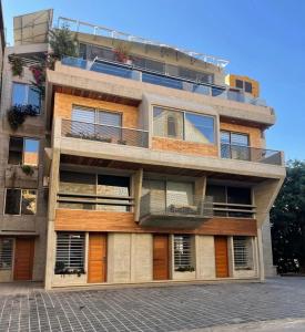 an apartment building with balconies on the side of it at Mini 1BR Studio Central Broumana with Sea View in Broummana