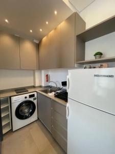 a kitchen with a refrigerator and a washing machine at Mini 1BR Studio Central Broumana with Sea View in Broummana