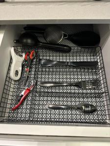 a metal shelf with utensils in a drawer at Mini 1BR Studio Central Broumana with Sea View in Broummana