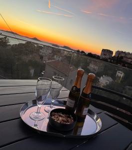 two bottles of wine and two glasses on a table at Villa Luna maison d'architecte in Marseille +15 photos