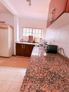 an empty kitchen with a counter and a refrigerator at OLO Hostel Boutique & Bar Club SANTA FE in Santa Fe +18 photos