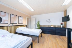 a hospital room with two beds and a tv at Orange Suite Schliengen 1 in Schliengen