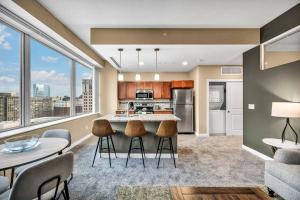 a kitchen and living room with a large window at Downtown Suite w/ Amazing Views in Cleveland
