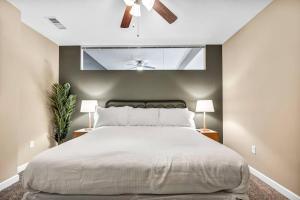 a bedroom with a large bed with a ceiling fan at Downtown Suite w/ Amazing Views in Cleveland