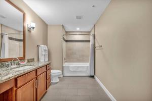 a bathroom with a shower and a toilet and a sink at Downtown Suite w/ Amazing Views in Cleveland +17 photos