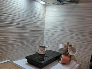 a white bathroom with a toilet and a black table at Apartman Stars in Podgorica +17 photos