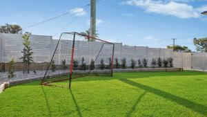 a net in the middle of a field of grass at The Haven - Ettalong in Ettalong Beach
