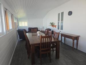 a dining room with a wooden table and chairs at Horseshoe House - Gympie in Gympie +10 photos